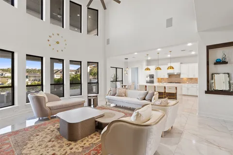 a kitchen with kitchen island granite countertop a stove a oven a oven and a refrigerator