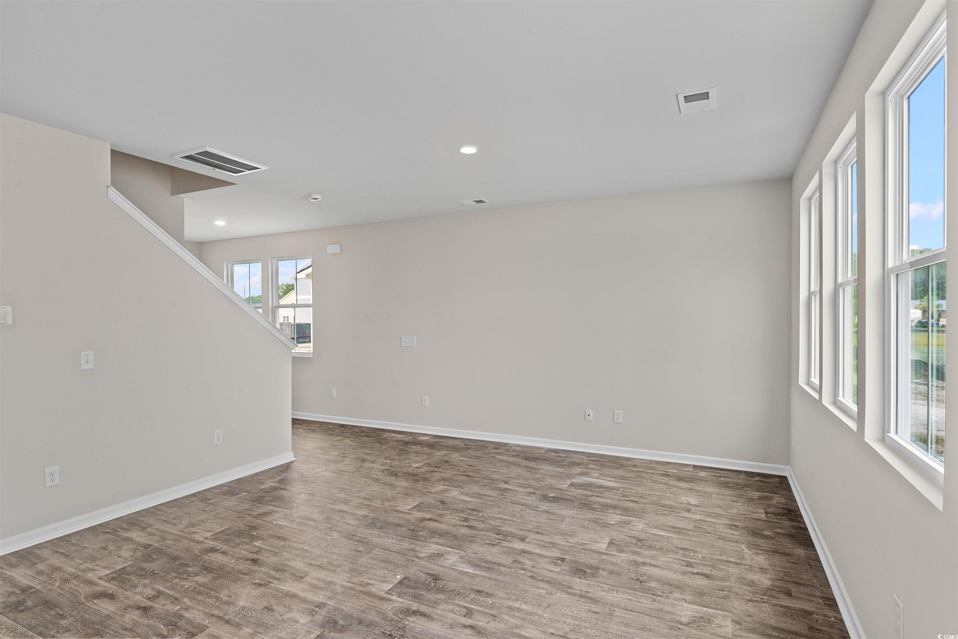 455 Falling Leaf Loop Myrtle Beach, SC 29588 - Photo 11 of 15 Empty room featuring hardwood / wood-style floorin