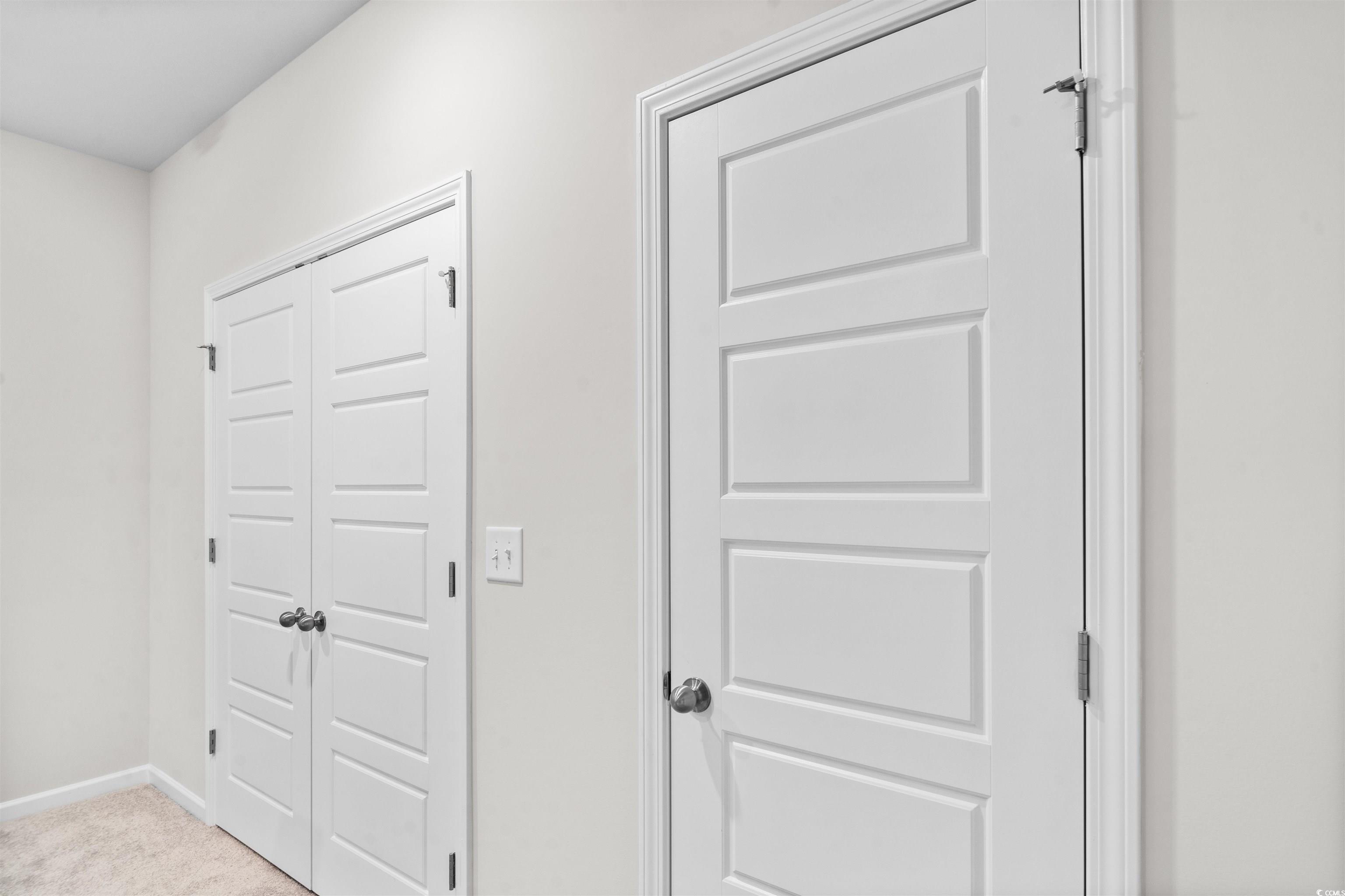 455 Falling Leaf Loop Myrtle Beach, SC 29588 - Photo 12 of 15 Hallway featuring light colored carpet