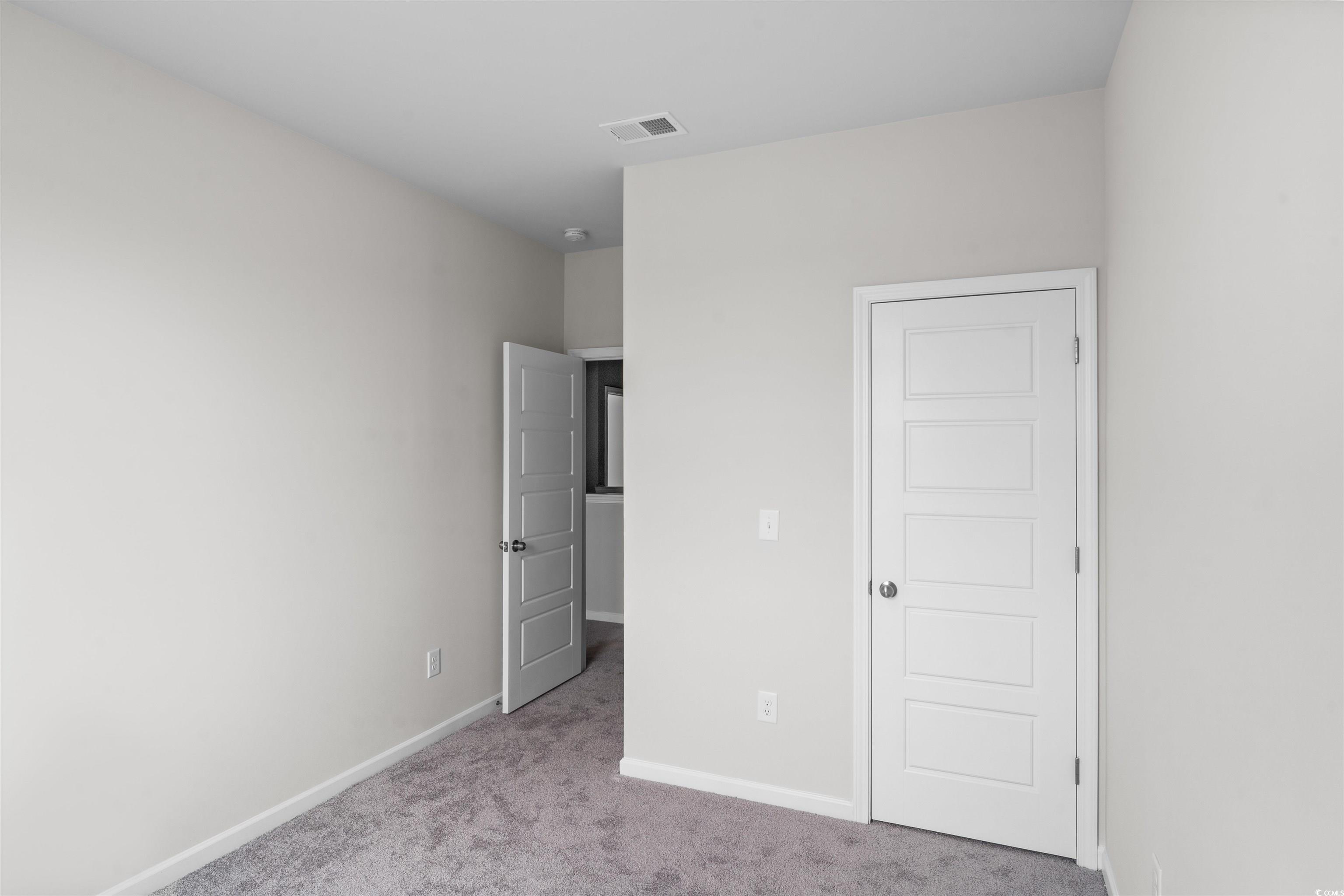 455 Falling Leaf Loop Myrtle Beach, SC 29588 - Photo 5 of 15 Unfurnished bedroom with light colored carpet