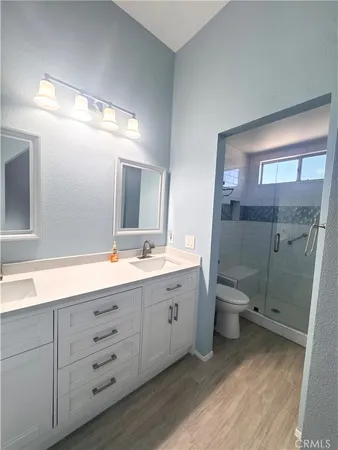 a view of a livingroom with wooden floor and a flat screen tv