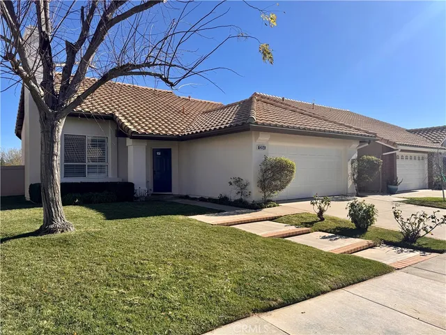 wooden floor fireplace and windows in an empty room