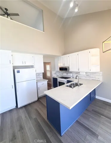 a kitchen with stainless steel appliances granite countertop a sink a stove and cabinets