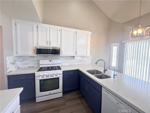 an empty room with a window and a chandelier fan