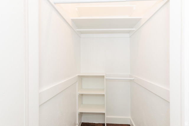 227 West 200 North Logan, UT 84321 - Photo 26 of 44 Closet with built-in shelving, white walls, and wood-finish flooring