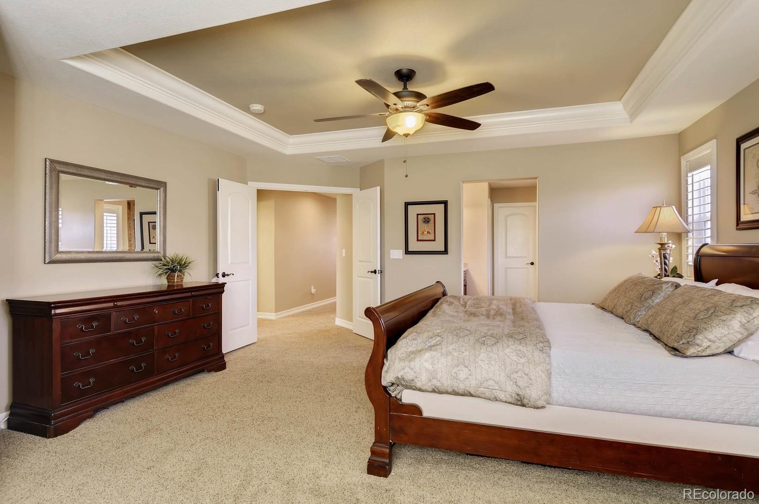 10560 Sundial Rim Road Highlands Ranch, CO 80126 - Photo 12 of 27 a bedroom with a bed and a dresser