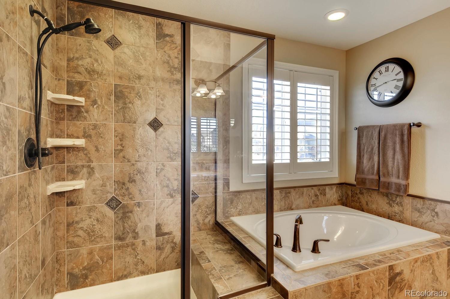 10560 Sundial Rim Road Highlands Ranch, CO 80126 - Photo 13 of 27 a bathroom with a bathtub and a shower