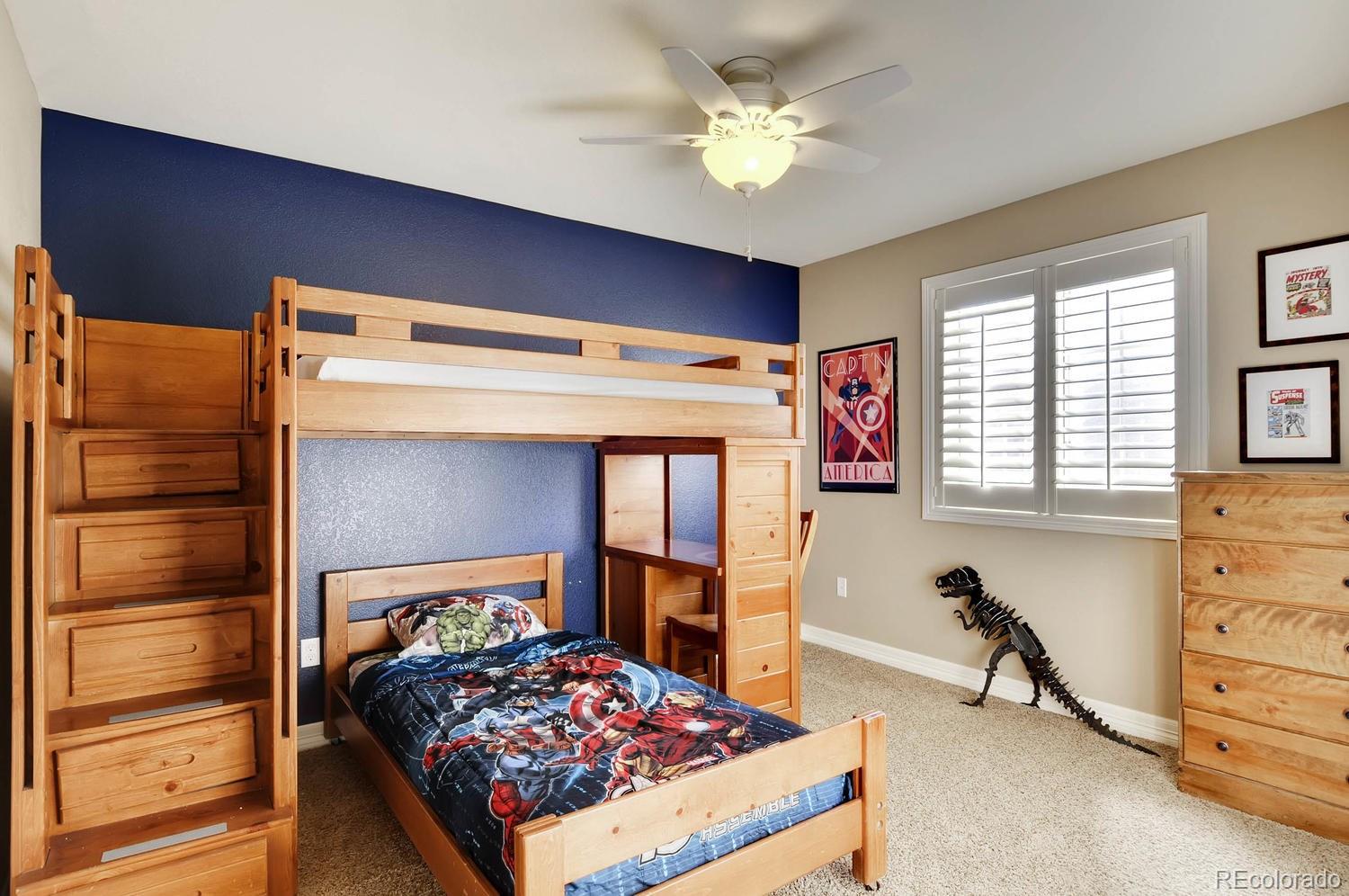 10560 Sundial Rim Road Highlands Ranch, CO 80126 - Photo 16 of 27 a bedroom with a bed and a chandelier