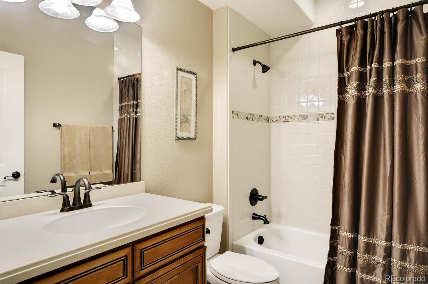 10560 Sundial Rim Road Highlands Ranch, CO 80126 - Photo 19 of 27 a bathroom with a sink and a mirror