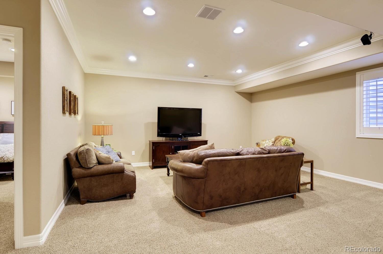 10560 Sundial Rim Road Highlands Ranch, CO 80126 - Photo 20 of 27 a living room with furniture and a flat screen tv