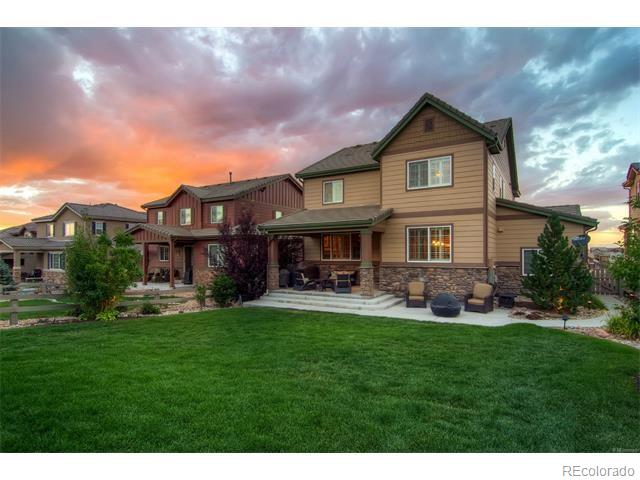 10560 Sundial Rim Road Highlands Ranch, CO 80126 - Photo 24 of 27 a front view of a house with a yard table and chairs
