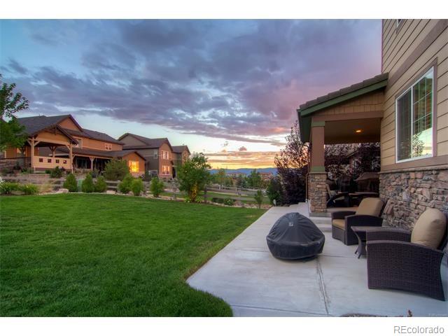 10560 Sundial Rim Road Highlands Ranch, CO 80126 - Photo 25 of 27 a view of a house with backyard sitting area and garden