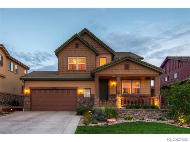 10560 Sundial Rim Road Highlands Ranch, CO 80126 - Photo 3 of 27 a front view of a house with a yard and garage