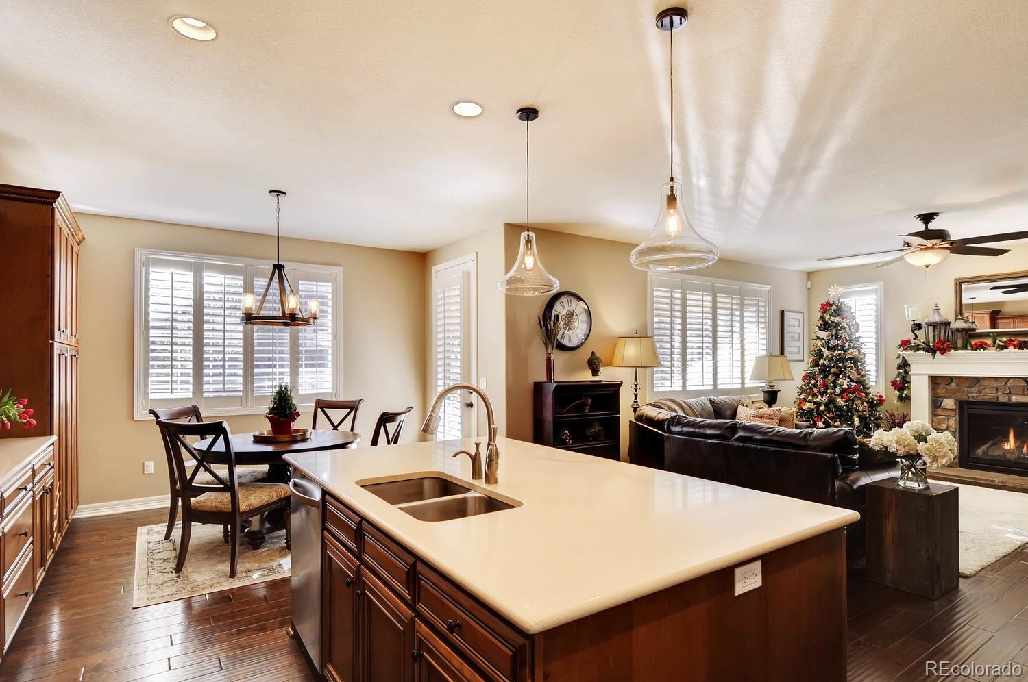 10560 Sundial Rim Road Highlands Ranch, CO 80126 - Photo 5 of 27 a view of a dining room and livingroom with furniture wooden floor a chandelier