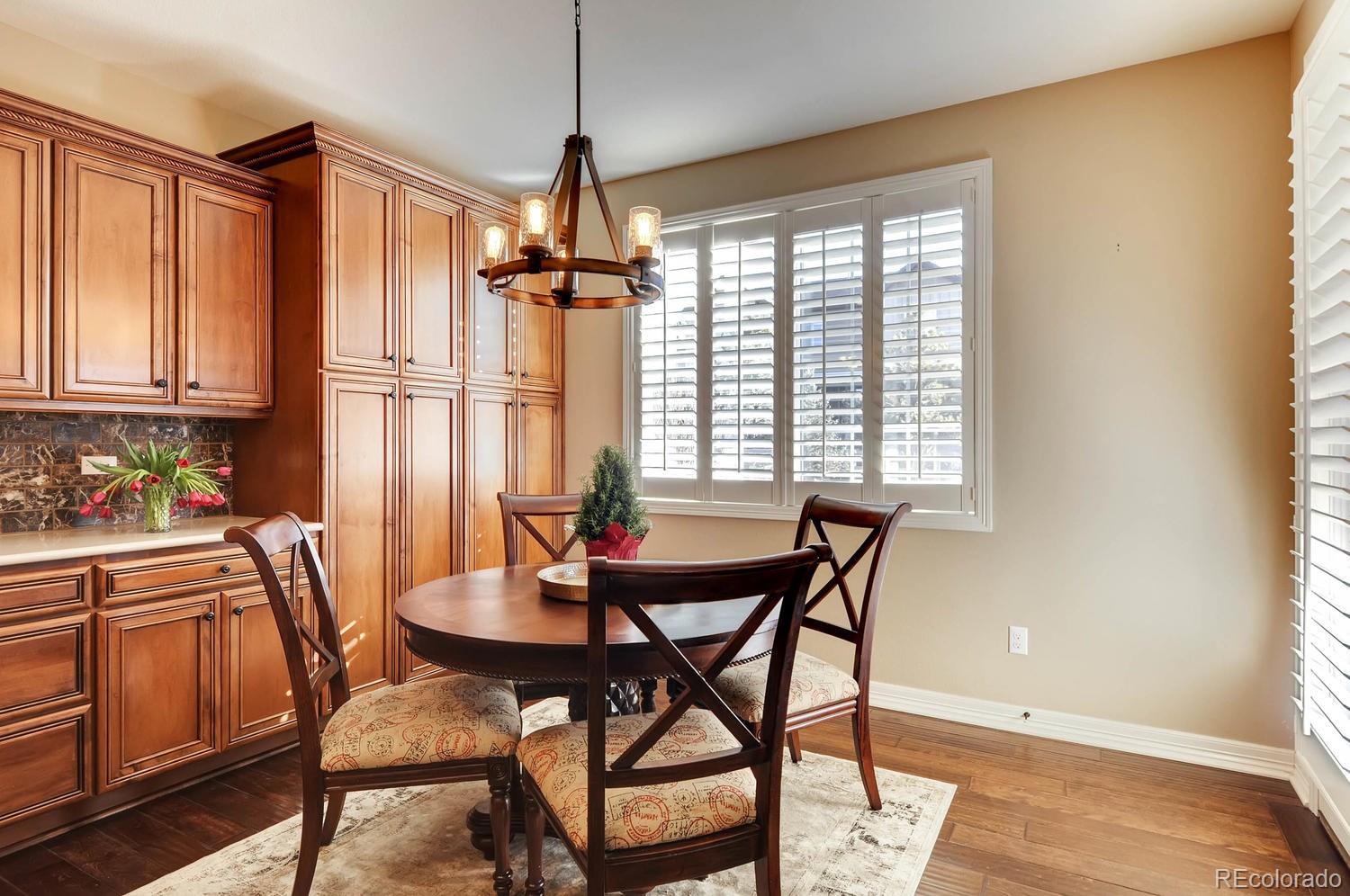 10560 Sundial Rim Road Highlands Ranch, CO 80126 - Photo 6 of 27 a view of a dining room with furniture window and wooden floor
