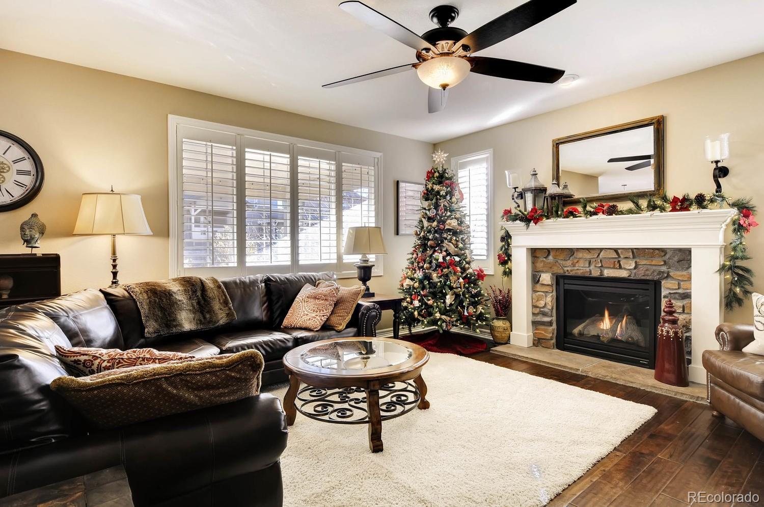 10560 Sundial Rim Road Highlands Ranch, CO 80126 - Photo 7 of 27 a living room with furniture a window and a fireplace