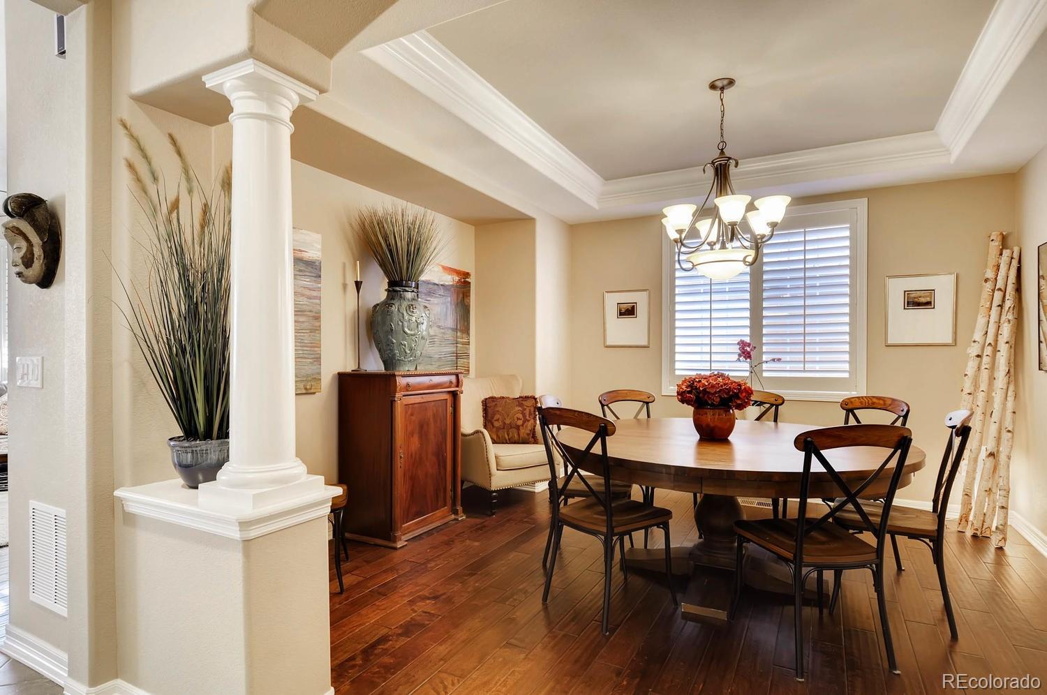 10560 Sundial Rim Road Highlands Ranch, CO 80126 - Photo 9 of 27 a view of a dining room with furniture and chandelier