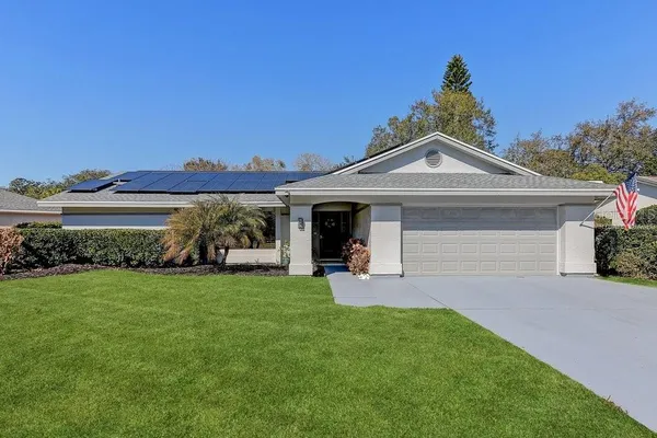 a front view of a house with a garden and yard