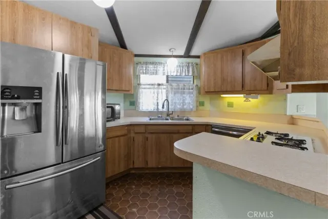 a kitchen with stainless steel appliances granite countertop a refrigerator and a stove
