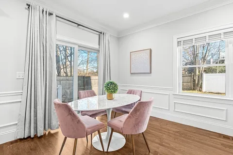 a dining room with furniture and wooden floor
