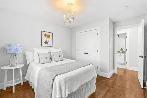 a bedroom with a bed and a chandelier