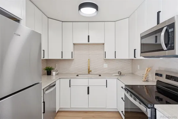 a kitchen with a sink cabinets and stainless steel appliances