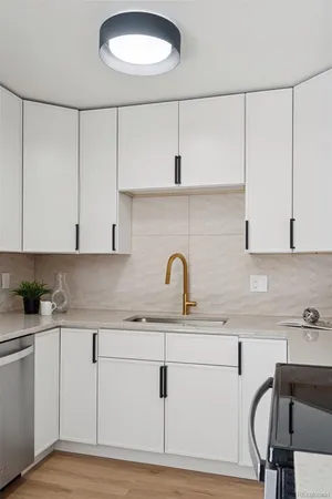 a kitchen with a sink cabinets and appliances