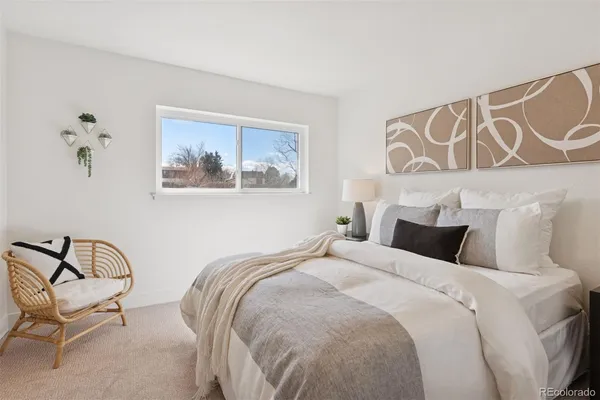 a bedroom with a bed and chair