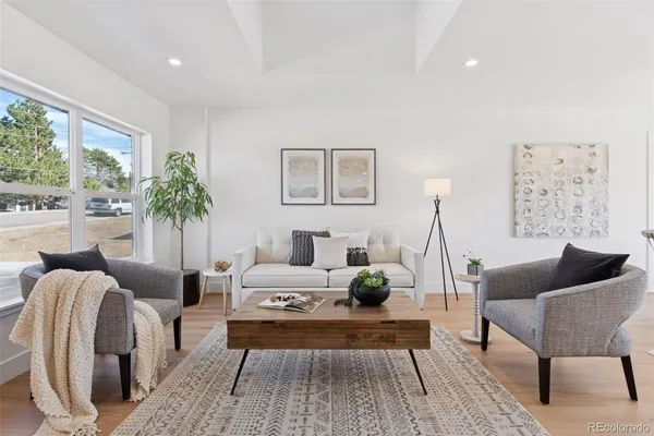 a living room with furniture and a large window