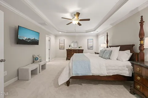 a spacious bedroom with a bed and a chandelier