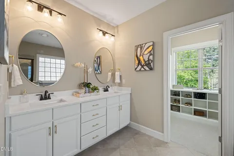 a bathroom with a double vanity sink and a mirror