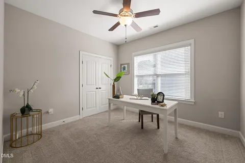 a work room with furniture and windows
