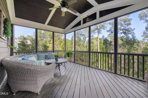 a balcony with furniture and wooden floor
