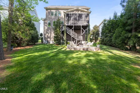 a view of a house with a yard and sitting area