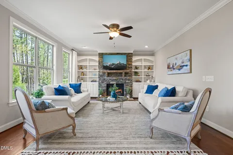 a living room with fireplace furniture and a flat screen tv