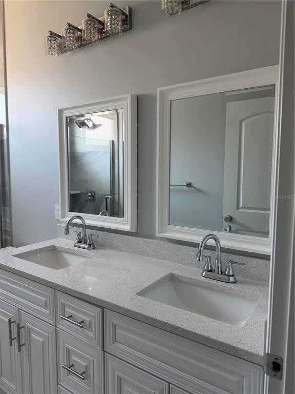 5315 3rd Bradenton, FL 34203 - Photo 12 of 41 a bathroom with double vanity sink and a mirror