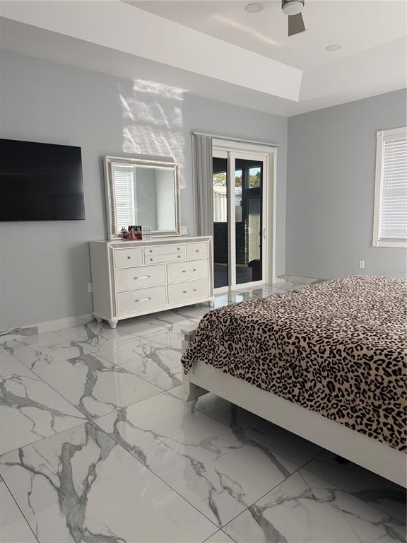 5315 3rd Bradenton, FL 34203 - Photo 25 of 41 a bedroom with a large bed and a flat tv screen on dresser