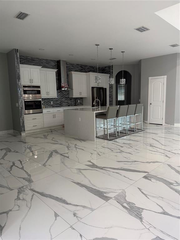 5315 3rd Bradenton, FL 34203 - Photo 7 of 41 a kitchen with stainless steel appliances kitchen island granite countertop a sink and cabinets