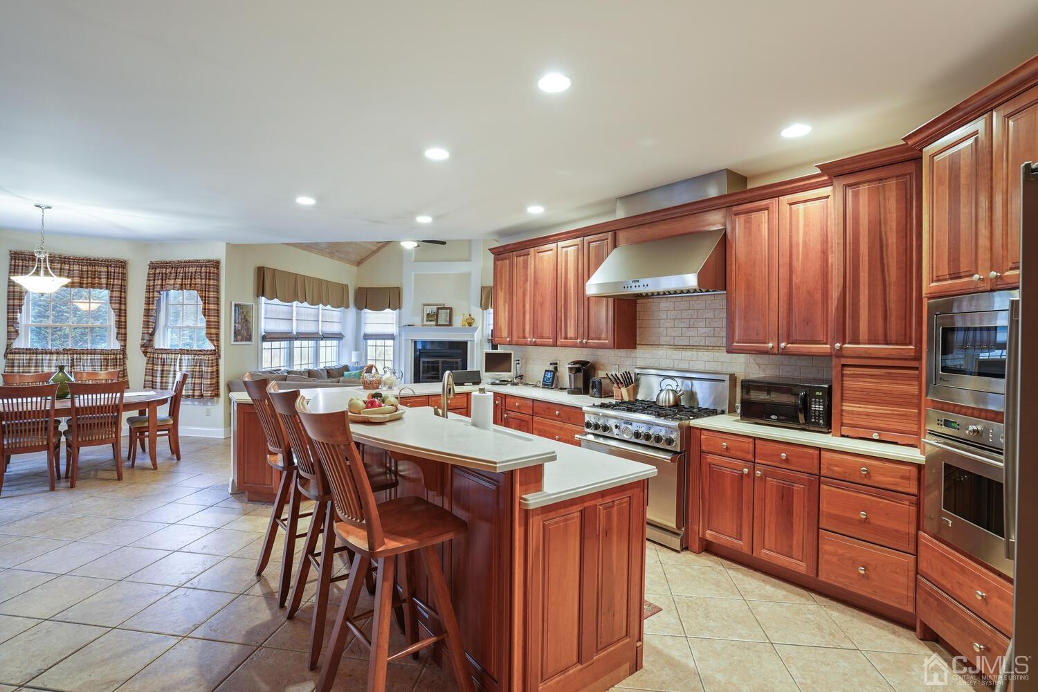73 Davidson's Mill Road North Brunswick, NJ 08902 - Photo 18 of 51 a kitchen with stainless steel appliances granite countertop wooden cabinets a dining table and chairs