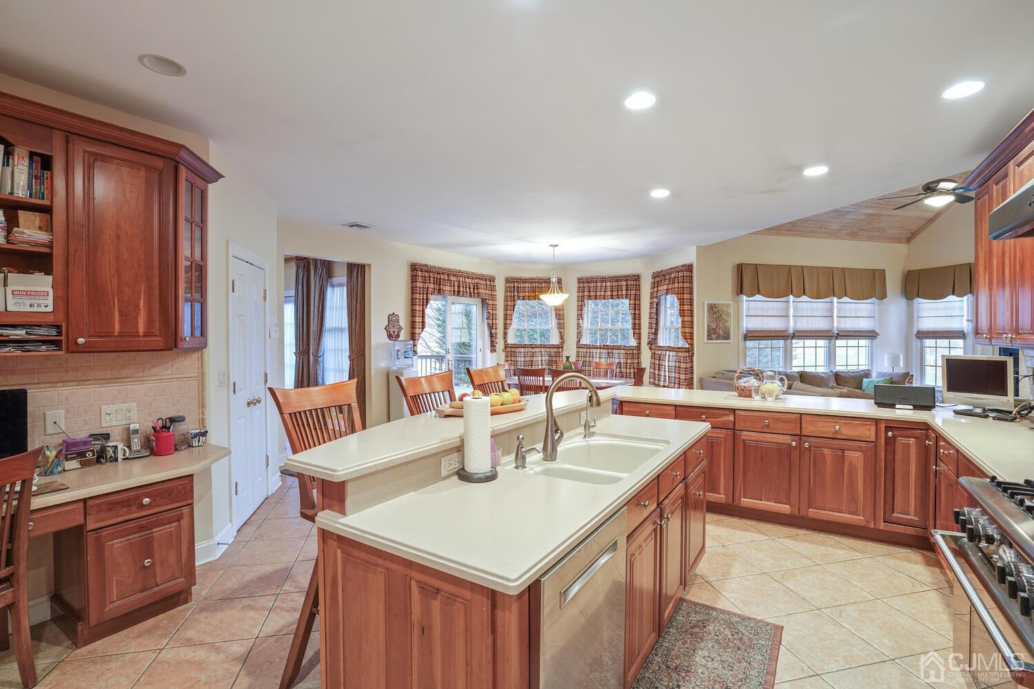 73 Davidson's Mill Road North Brunswick, NJ 08902 - Photo 21 of 51 a kitchen with a stove a sink a dining table and chairs