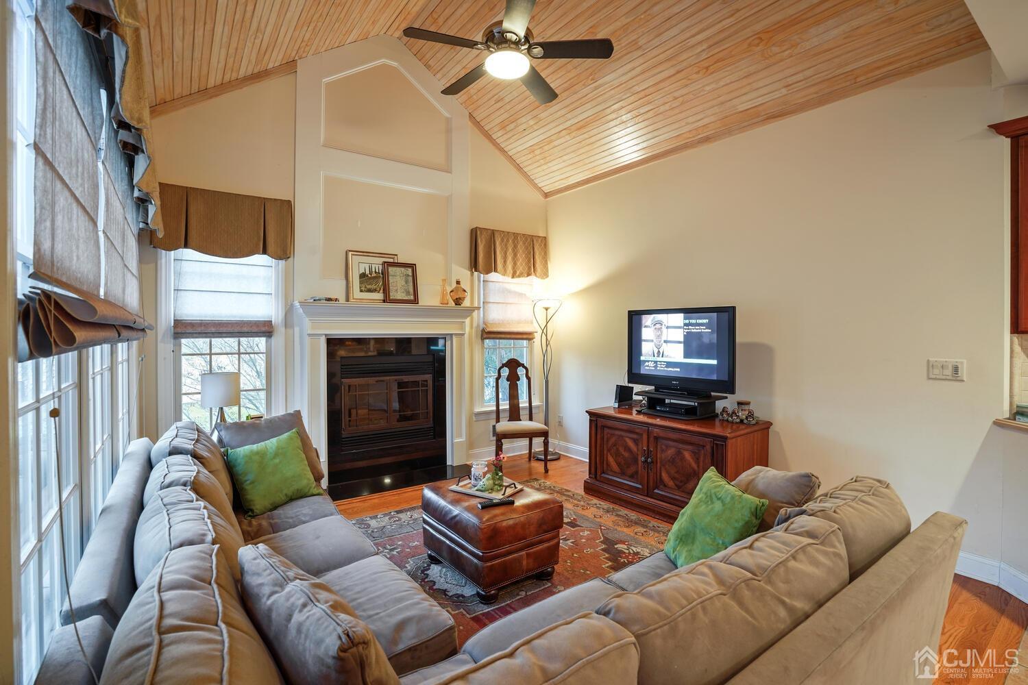73 Davidson's Mill Road North Brunswick, NJ 08902 - Photo 24 of 51 a living room with furniture a fireplace and a ceiling fan