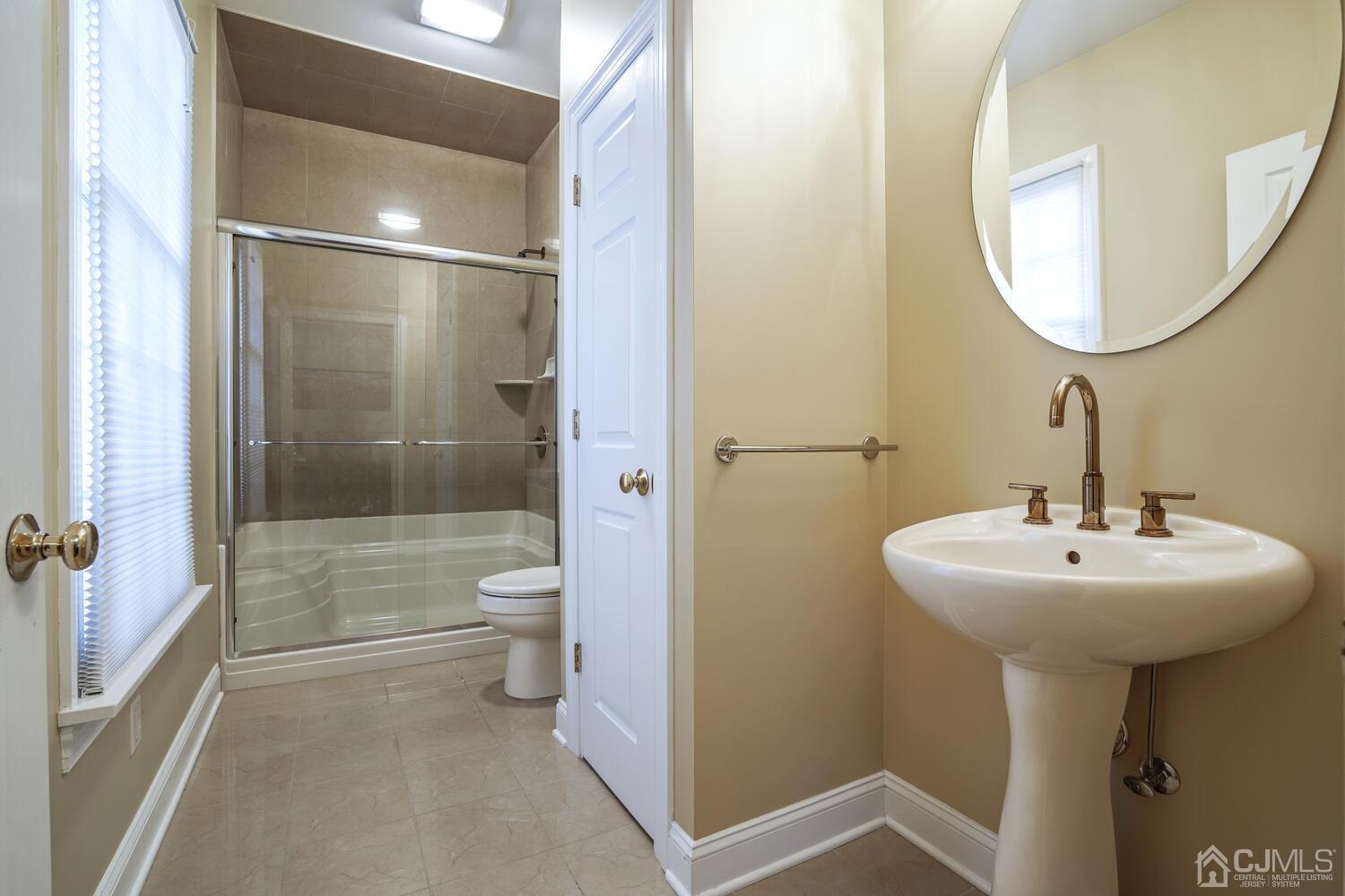 73 Davidson's Mill Road North Brunswick, NJ 08902 - Photo 28 of 51 a bathroom with a sink a toilet and shower