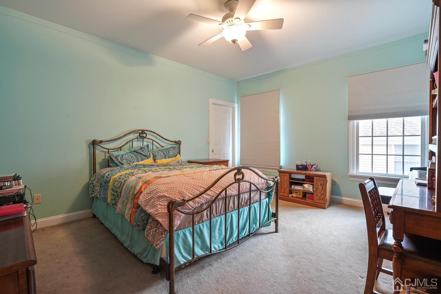 73 Davidson's Mill Road North Brunswick, NJ 08902 - Photo 34 of 51 a bedroom with a bed and a chandelier