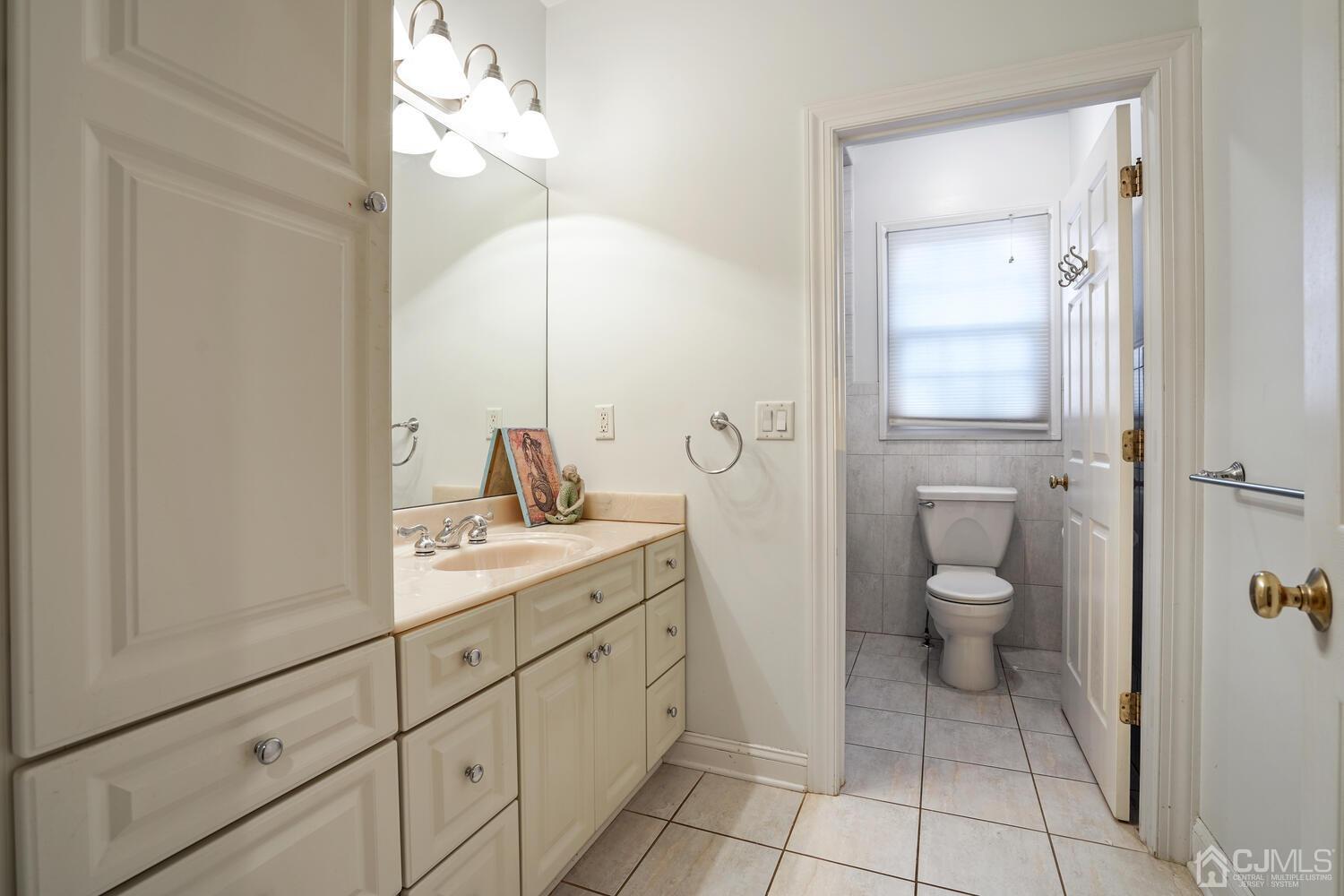 73 Davidson's Mill Road North Brunswick, NJ 08902 - Photo 35 of 51 a spacious bathroom with a granite countertop toilet sink and mirror