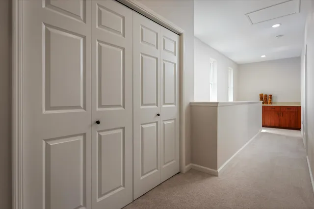 an empty room with closet and windows