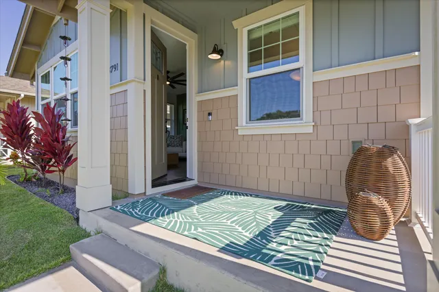 a living room with furniture flat screen tv and a large window