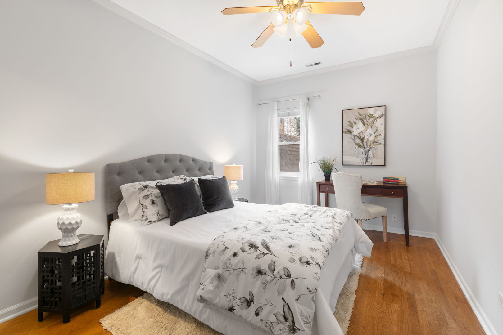 629 West Sheridan Road, Unit 1D Chicago, IL 60613 - Photo 11 of 17 a bedroom with a bed and a chandelier