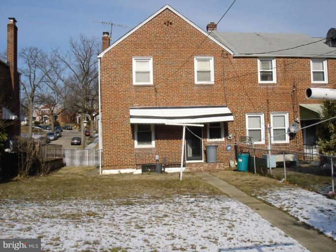 1901 Ramblewood Road Baltimore, MD 21239 - Photo 1 of 7 a front view of a house with a yard