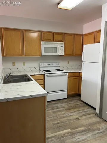 a kitchen with a sink a stove and refrigerator