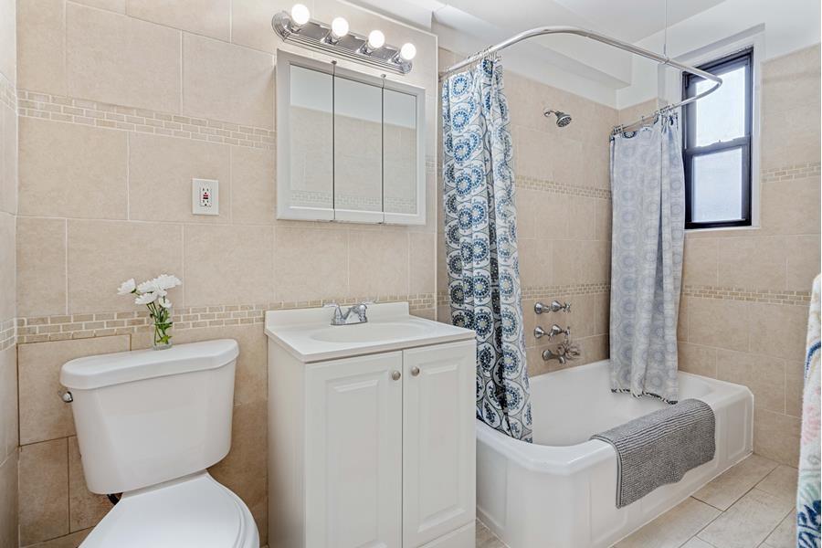 657 East 26th Street, Unit 4K Brooklyn, NY 11210 - Photo 5 of 6 a bathroom with a sink a toilet and shower